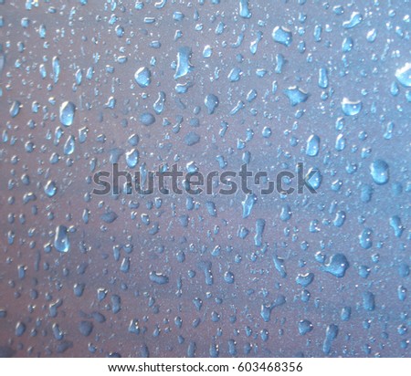 Raindrops on a smooth, blue surface.
