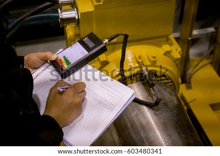 Technician or engineer recording data vibration measurement of motor or equipment in power plant Royalty-Free Stock Photo #603480341