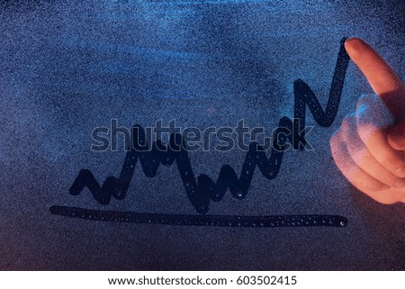Hand drawing graphic chart on fog window glass. Graphic symbol on frozen window texture