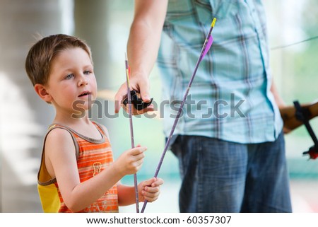Closeup portrait of father and son with archery arrows Royalty-Free Stock Photo #60357307