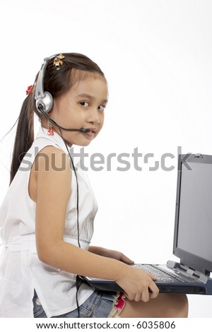 a young girl typing on a laptop