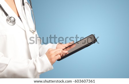 Female doctor holding tablet with blue background 