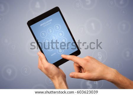 Female fingers touching tablet with locked device requiring passcode