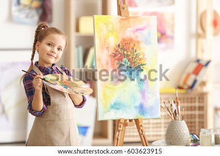 Cute little artist in studio Royalty-Free Stock Photo #603623915