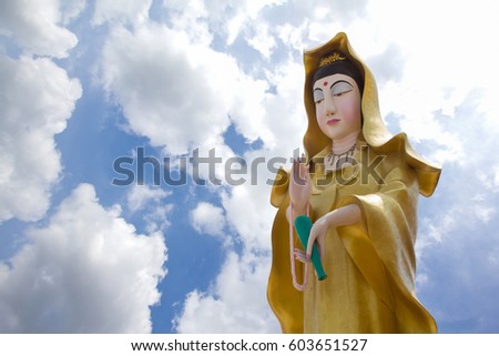  Stutue of GuanYin with blue sky back ground