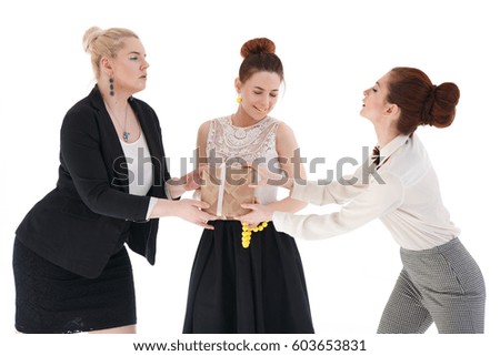 Three girls girlfriends holding a festive box, isolated on white background.