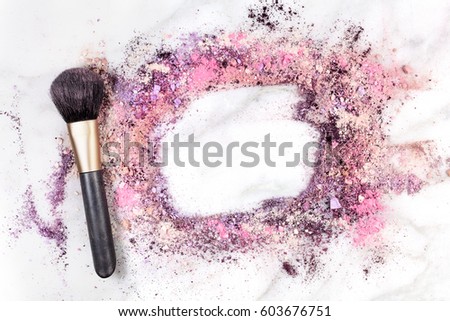 Makeup brush on white marble background, with traces of powder and blush forming a frame. A horizontal template for a makeup artist's business card or flyer design, with copy space