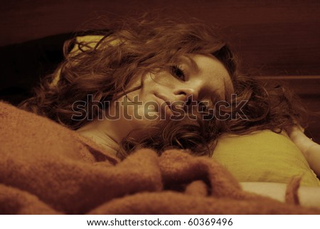 Portrait of young sad girl in bedroom