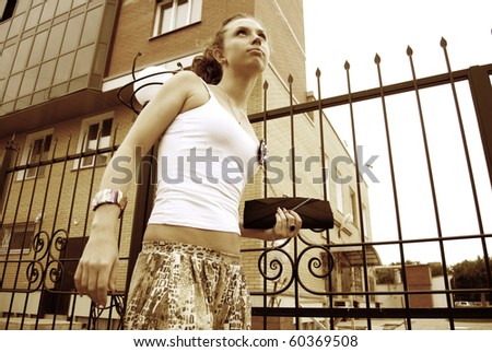 Portrait of young sad girl walking on the street