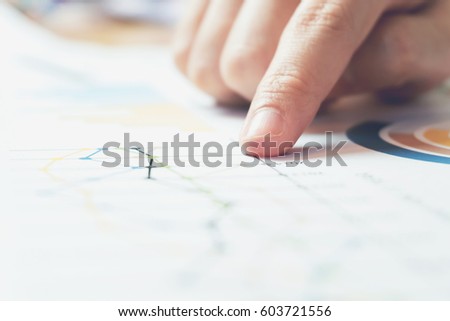 business woman hand working on wooden desk in office and there are many documents, graphs. Can be attributed to financial articles. Royalty-Free Stock Photo #603721556