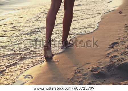 The girl runs barefoot along the sandy beach of the sea. Photo toned in the style of instagram