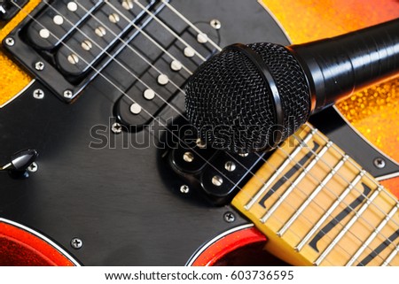 Microphone  on a  guitar background. Music art concept.