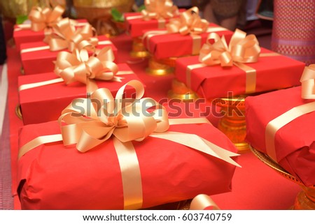 gift box collection on red tied with gold bow