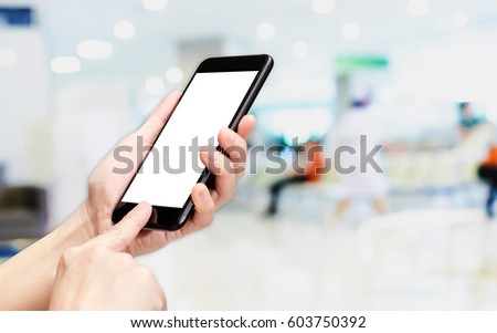 Hand click mobile phone with blur patient at hospital background bokeh light,White screen mock up template for adding your design or your text.