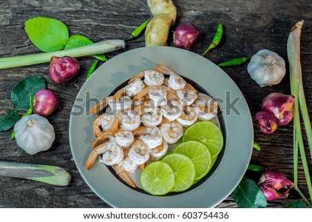 shrimp with lemon on dish and Shallots with Lemongrass and chilli on old wooden floor 