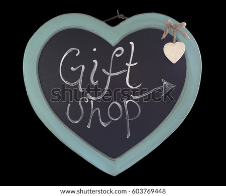 Hanging wooden heart with a chalkboard centre with Gift Shop and an arrow written on it and a small cream hanging heart. 
