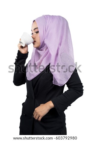 Beautiful modern Young Asian Muslim business woman drinking coffee,isolated on white background.