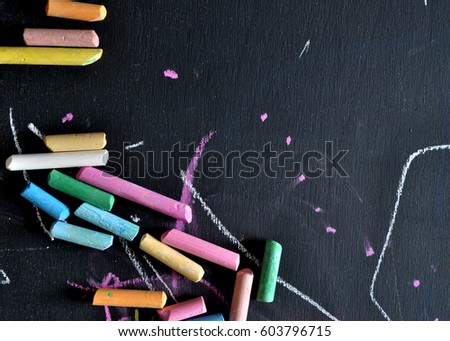 Blackboard with colored chalks