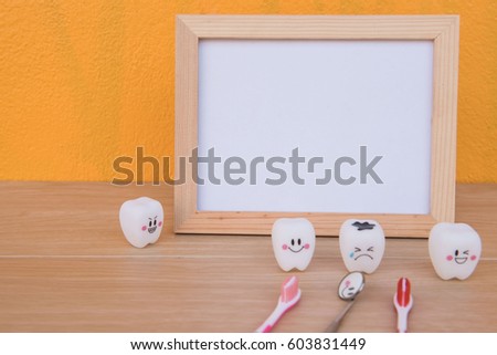
photo Frame and Model toys teeth in dentistry on a wooden on Yellow background . Concept for health.
