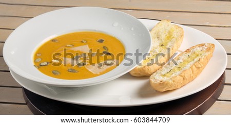 the pumpkin soup strewed with pumpkin sunflower seeds with bred