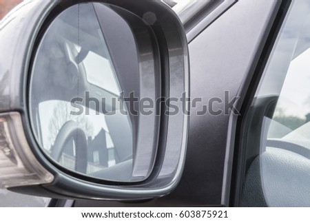 Car side rear view mirror on a modern car - wing mirror