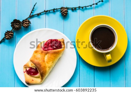 Still life with cup of tea and sweets on the wooden background