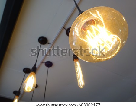 Group of Edison style bulbs are hanging on ceiling and classic design room like sci fi room.