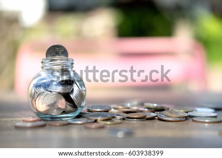 Coins in glass jar for money saving for housing,financial concept