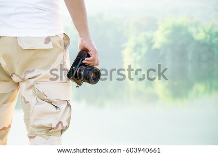 Man with photo camera Fashion Travel Lifestyle outdoor foggy nature Travel Lifestyle vacations concept