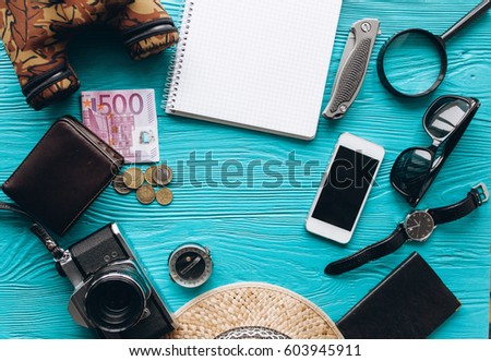 Top view of travel accessories set on wooden background with copy space Royalty-Free Stock Photo #603945911