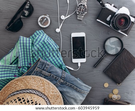 Top view of travel accessories set on wooden background with copy space Royalty-Free Stock Photo #603945959