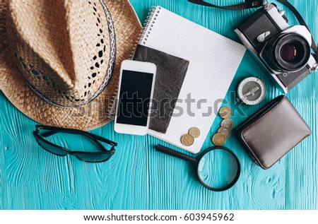 Top view of travel accessories set on wooden background with copy space Royalty-Free Stock Photo #603945962