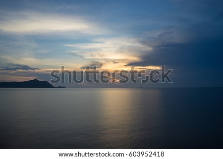 sunset with reflection on blue sea
