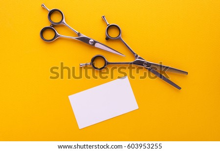 Professional Scissors and business card on yellow