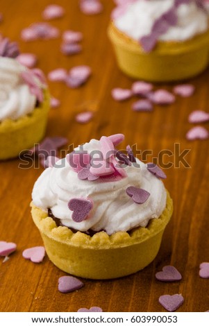 mini tart with whipped cream and pink heart ornament