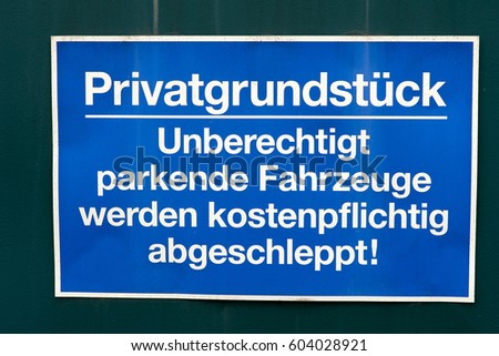 sign at a gate with the german words private property