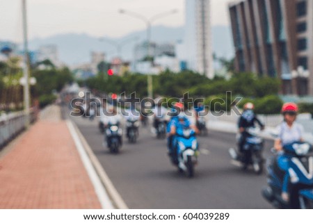Blurred picture of motorcycles on the road.