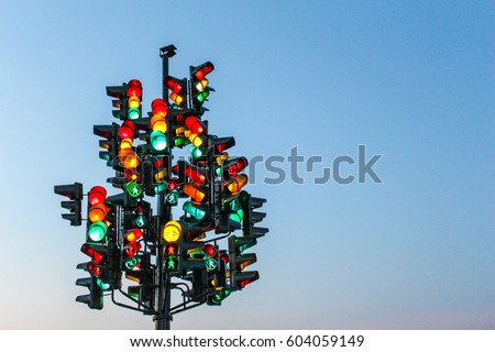 Traffic light tree with a lot of lamps under sky with a sunset. Royalty-Free Stock Photo #604059149