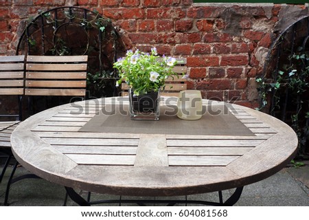Circle table and chairs of small cafe on a street of Bremen, Germany.                                           
