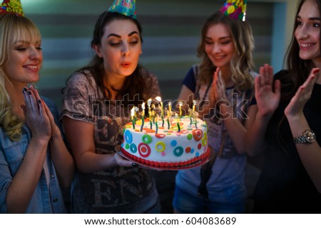 Birthday. Girls with a cake with candles.