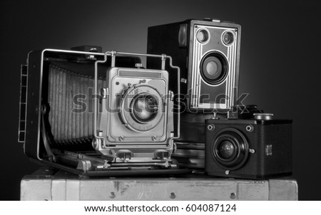 An group of retro cameras in black and white.