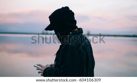 man using phone on sea background. Close-up of a European using the phone. Shallow focus