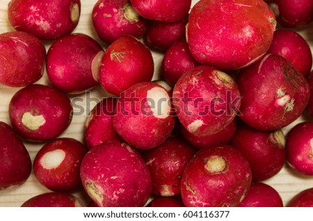 Fresh redishes on light wooden table background.