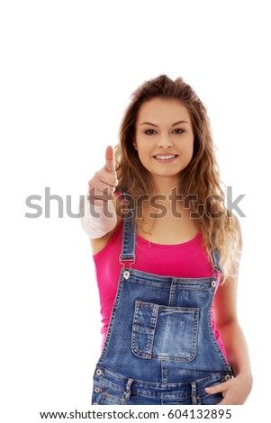Young happy woman showing thumb up