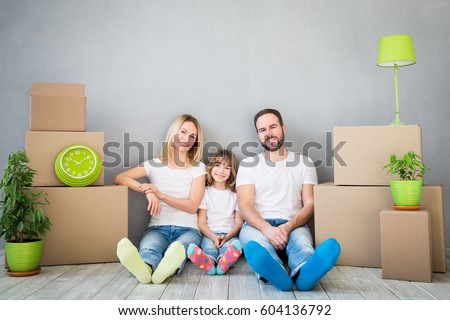 Happy family playing into new home. Father, mother and child having fun together. Moving house day and real estate concept Royalty-Free Stock Photo #604136792