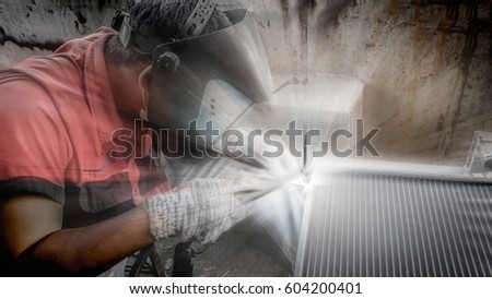 light Lens Flare Closeup of man wearing mask Welding steel structures and bright sparks  in a workshop