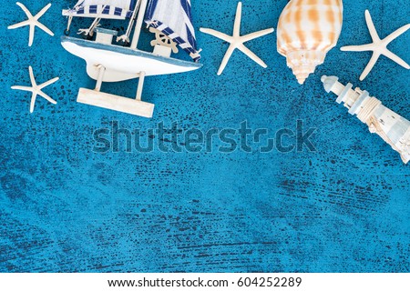 Top view Decorative sailing boats and marine items on wooden background. Sea objects on wooden planks. Selective focus. Place for text.