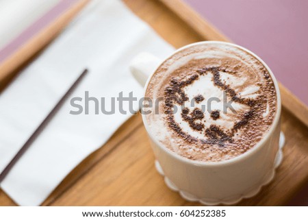 Coffee cup with artistic cream cat face decoration