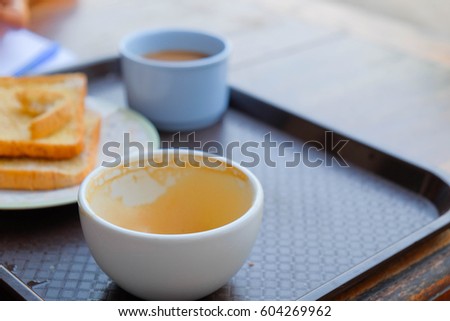 a selective focus picture of an empty cup of coffee on wooden table