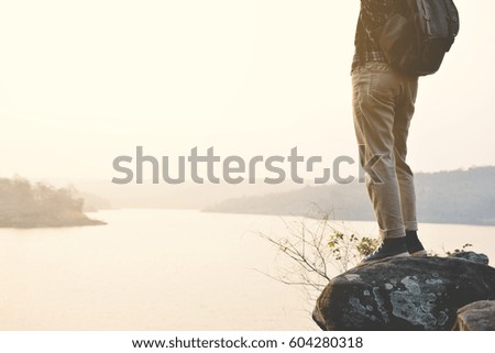 Happy Asian hipster man backpack in nature background, Relax time on holiday concept travel , color of vintage tone and soft focus
